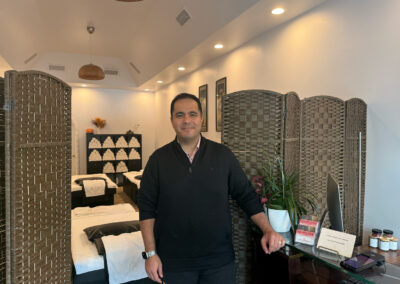 Piran Zarifian of Bao Foot Spa smiling standing next to front counter